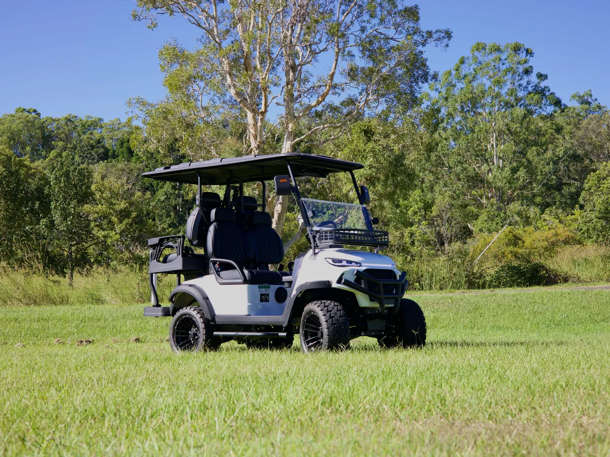 White JSH golf cart photographed in an open Australian field