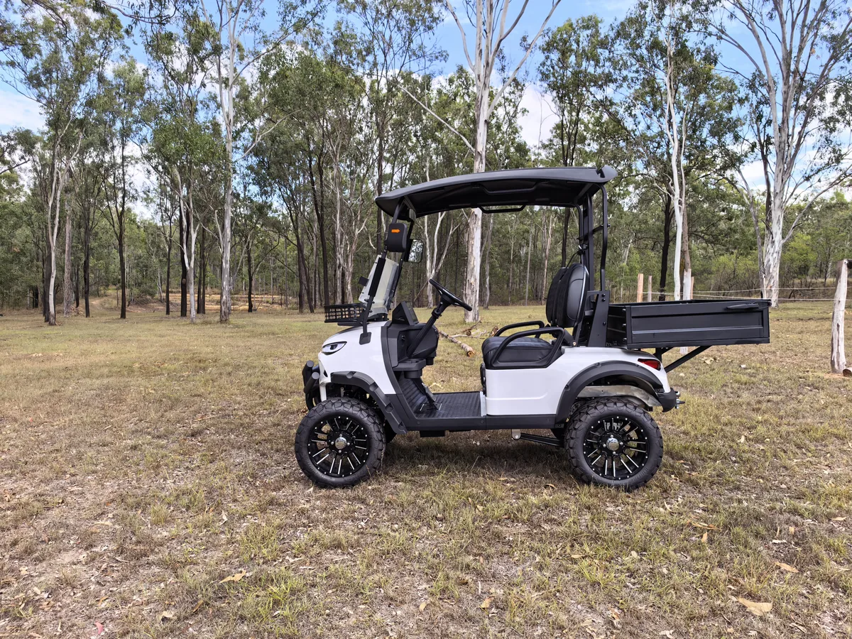 White JSH utility vehicle with tray bed in Australian bushland