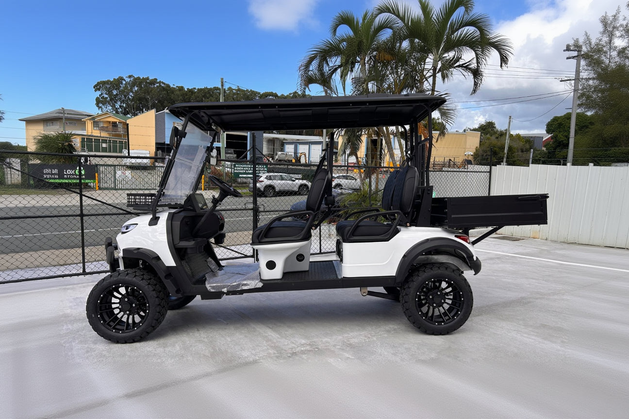 Complete side view of a white JSH0709 lifted four-seat utility buggy with rear cargo box