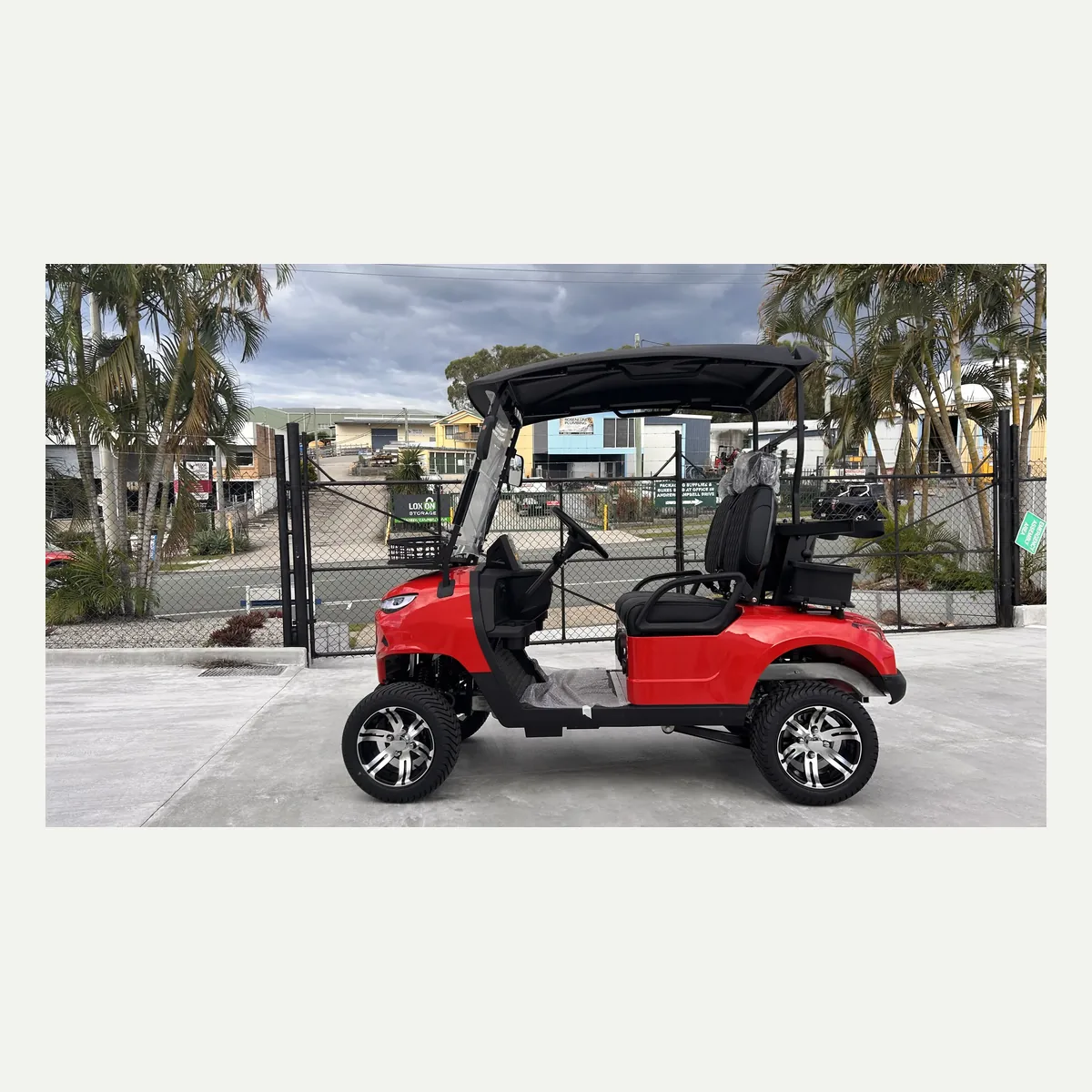 Red JSH0701 two-seat golf cart in side profile