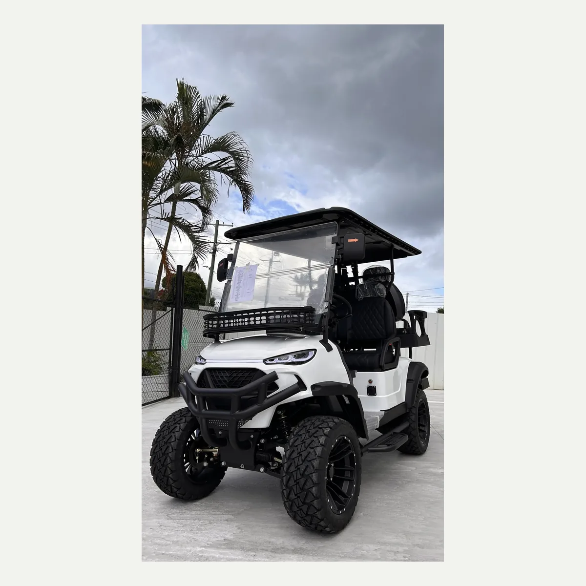 White JSH0702 lifted 2+2 golf cart from the front quarter