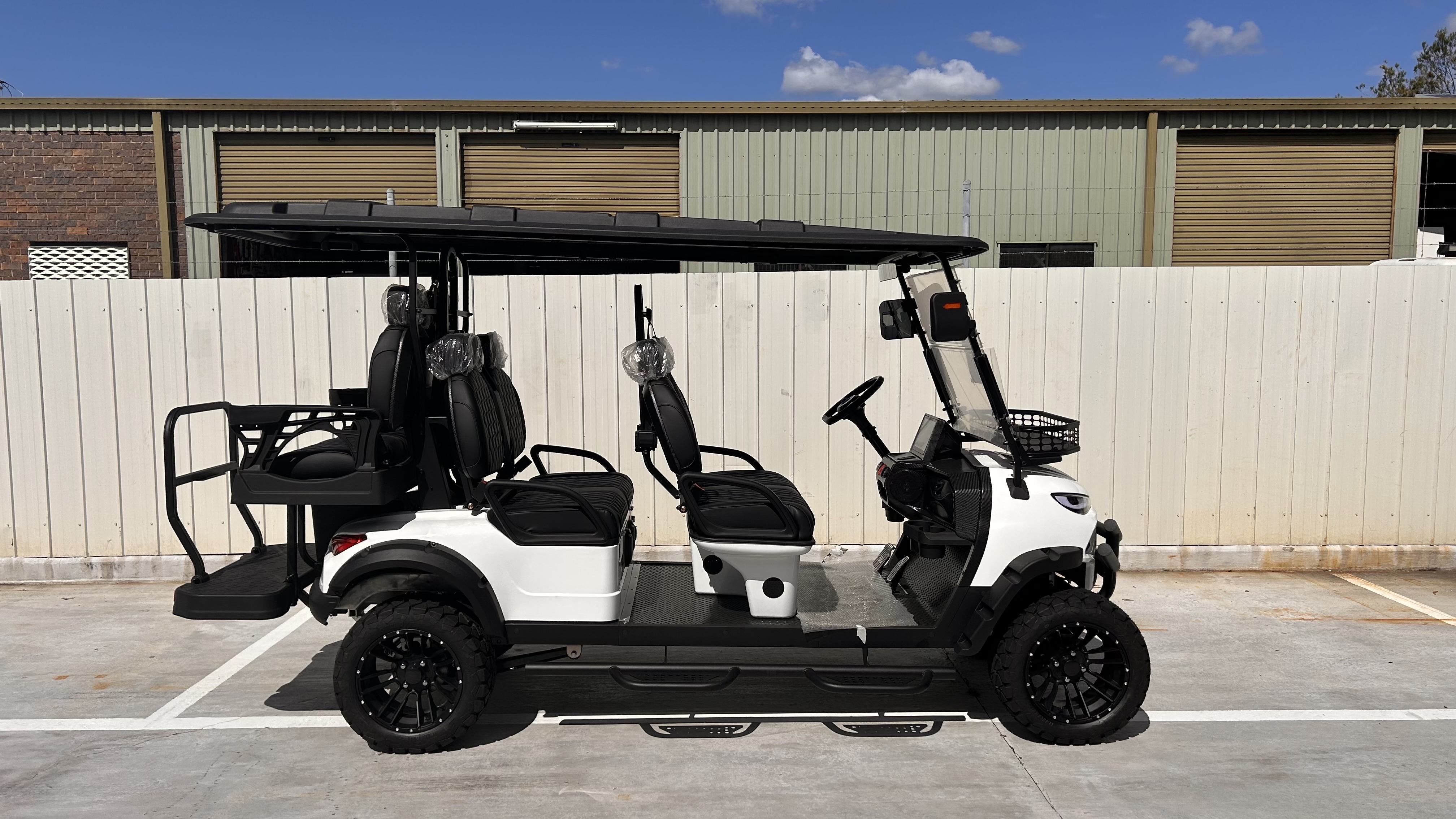 White JSH0704 lifted four plus two seat shuttle buggy in profile