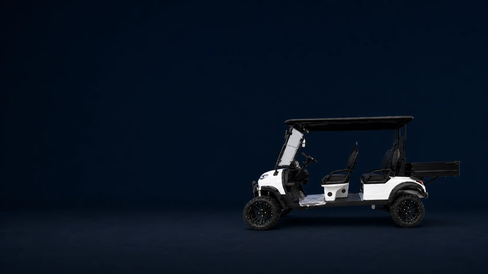 White JSH0709 four-seat electric utility vehicle with rear cargo box on a deep navy studio background
